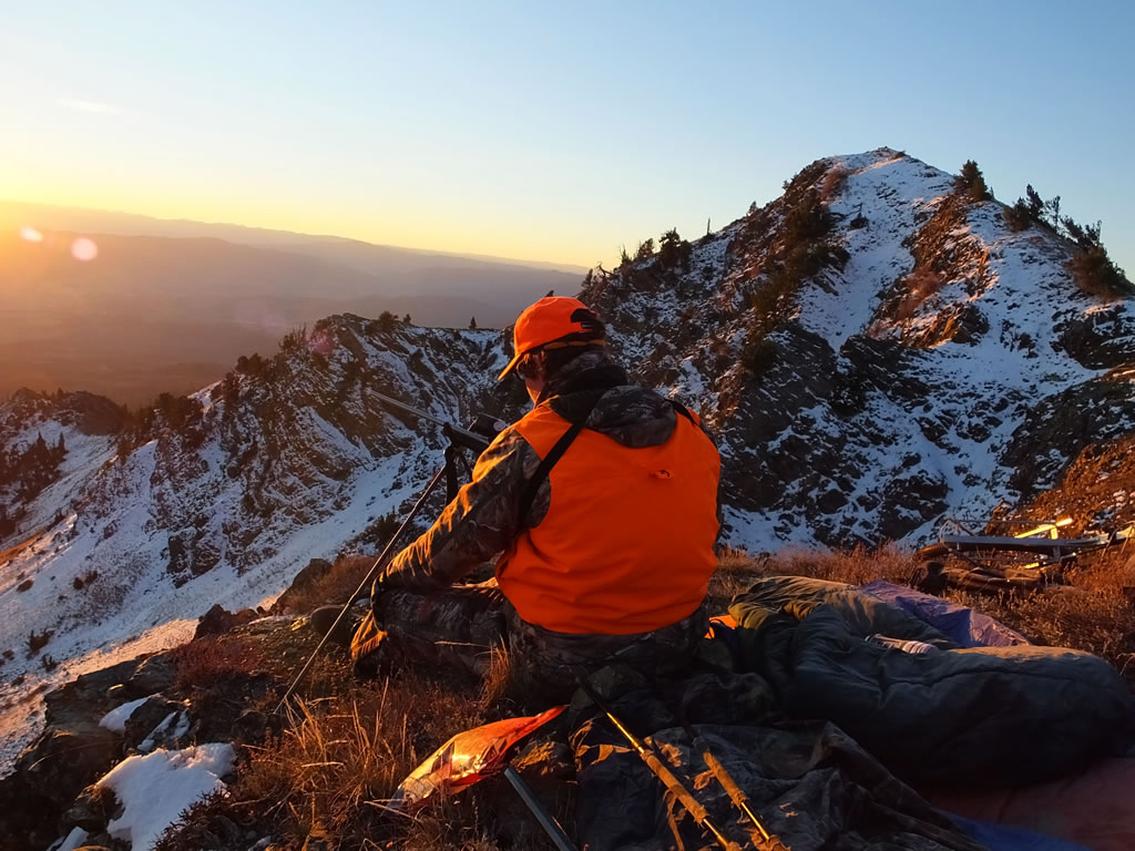 Deer Hunter on snow covered cliffs