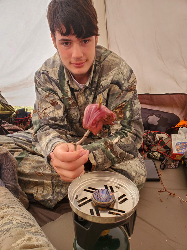 Cooking fresh tenderloin in the tent.
